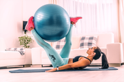 NPL athlete performing crunches with a yoga ball, blog shares tips on how to stay on track while working from home